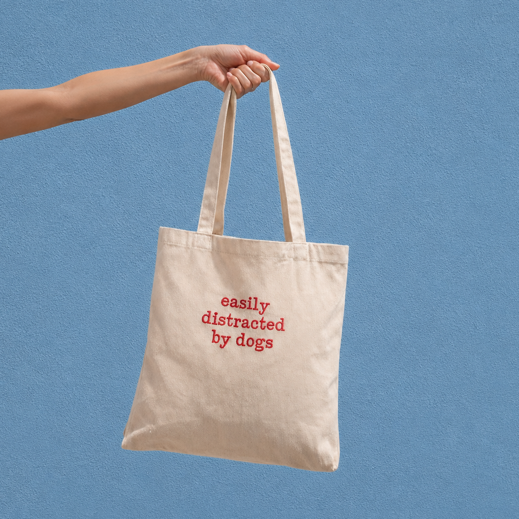 'Easily distracted by dogs' tote bag